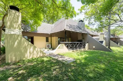 a house with a large yard in front of it at Sanbonani Resort Chalets in Hazyview
