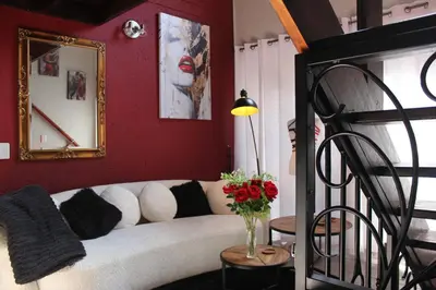 a living room with a white couch and red walls at The KinkyKabin in Sandton