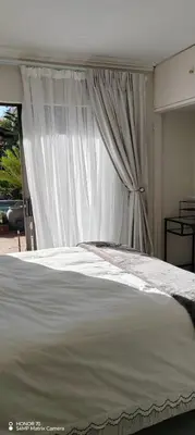 a white bed with a canopy in a bedroom at Casa LaMich Garden Venue and Spa in Midrand