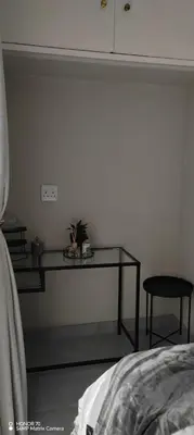 a bedroom with a table with a plant on it at Casa LaMich Garden Venue and Spa in Midrand