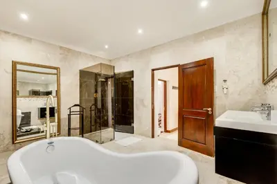 a bathroom with a tub and a sink and a shower at Concordia Boutique Venue in Midrand