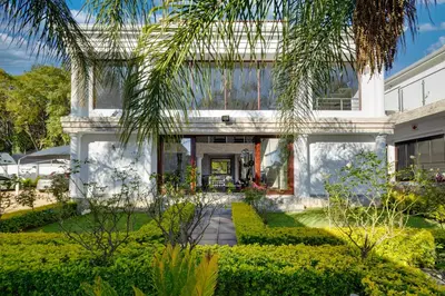 a house with a palm tree in front of it at Concordia Boutique Venue in Midrand