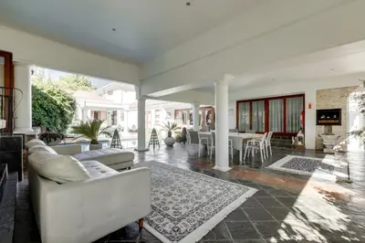a living room with two couches and a fireplace at Concordia Boutique Venue in Midrand