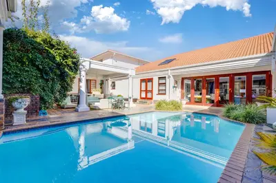 a swimming pool in front of a house at Concordia Boutique Venue in Midrand