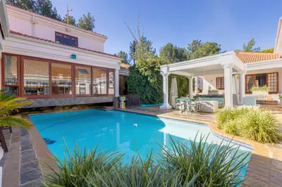 a swimming pool in the backyard of a home with a house at Concordia Boutique Venue in Midrand
