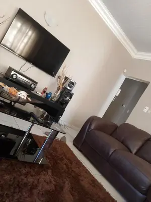 a living room with a couch and a flat screen tv at Safari Soul Villa in Hazyview