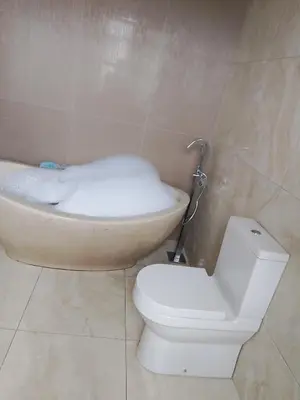 a bathroom with a toilet and a bath tub at Safari Soul Villa in Hazyview