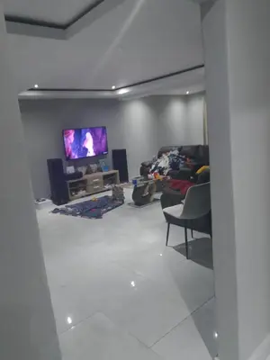 a living room with a couch and a flat screen tv at Safari Soul Villa in Hazyview