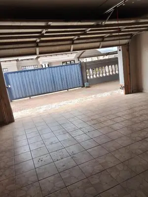 an empty room with a tile floor and a blue fence at Safari Soul Villa in Hazyview