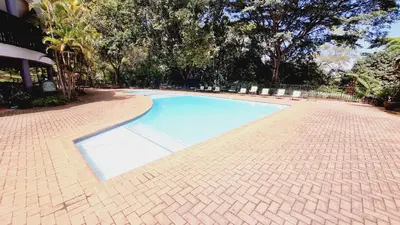 a blue swimming pool on a brick road at Timbers at Greenway Woods in White River