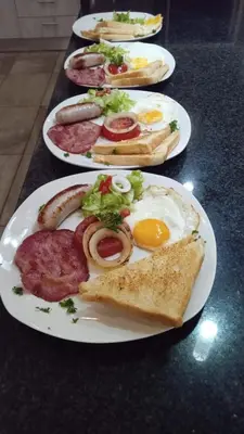 four plates of breakfast foods on a table at Antelope Farm Events in Pretoria