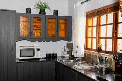 a kitchen with a microwave and a sink at Raasblaar at Benlize in Broederstroom