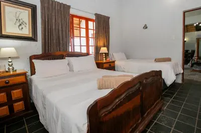 a bedroom with two beds with white sheets at Raasblaar at Benlize in Broederstroom