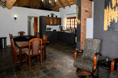 a kitchen and dining room with a table and chairs at Raasblaar at Benlize in Broederstroom