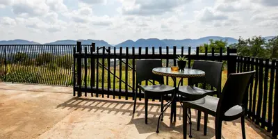 a table and chairs sitting next to a fence at Raasblaar at Benlize in Broederstroom