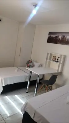 a room with two beds and a table in it at C-Rane Lodge 2 in Phalaborwa