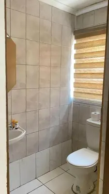 a bathroom with a toilet and a sink at C-Rane Lodge 2 in Phalaborwa