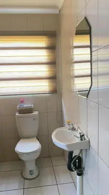 a bathroom with a toilet and a sink at C-Rane Lodge 2 in Phalaborwa