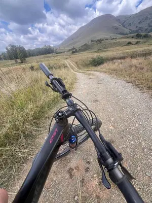 a bike is parked on a dirt road at Wagenbietjieshoek Wilgekraal Farmhouse in Lydenburg