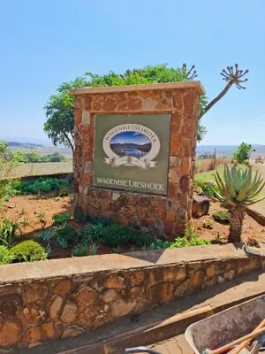 a sign for a waterhole visitor district in a field at Wagenbietjieshoek Wilgekraal Farmhouse in Lydenburg