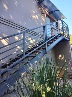 a metal staircase leading up to a building at 109 Mauser Avenue in Pretoria