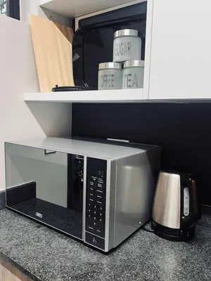a microwave sitting on top of a kitchen counter at Luxury Apartment in Mbombela, Nelspruit Mpumalanga in Boschrand