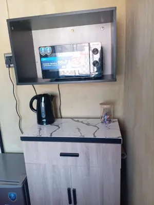 a microwave sitting on top of a counter at Comfy at Sosha in Soshanguve