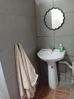a bathroom with a sink and a toilet and a mirror at Comfy at Sosha in Soshanguve