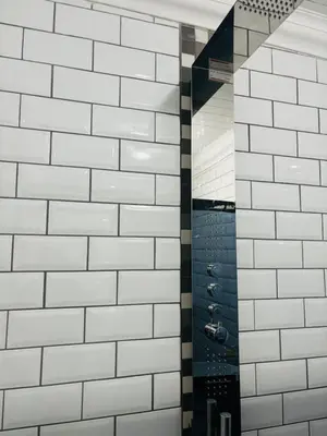 a bathroom with white tiled walls and a shower at The Secret Location in Pretoria