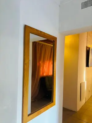 a mirror hanging on a wall in a room at The Secret Location in Pretoria
