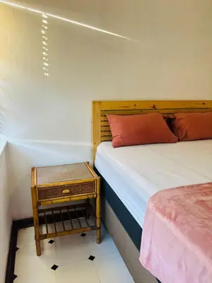 a bedroom with two beds and a night stand at The Secret Location in Pretoria