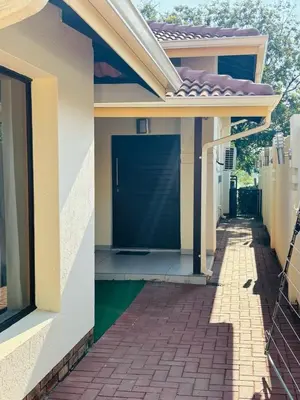 a house with a blue door and a walkway at Pecanwood Villa with lake view in Hartbeespoort