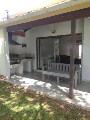 a patio with a bench and a grill at Pecanwood Villa with lake view in Hartbeespoort
