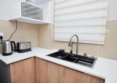 a kitchen with a sink and a microwave at La Genèse - S507 at Glen Park in Pretoria