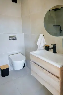 a bathroom with a white sink and a toilet at La Genèse - S507 at Glen Park in Pretoria
