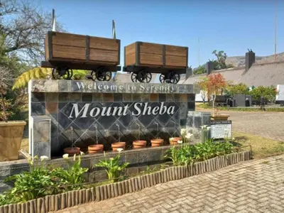 a sign with two train cars on top of it at Mount Sheba Rainforest & Resort in Pilgrimʼs Rest