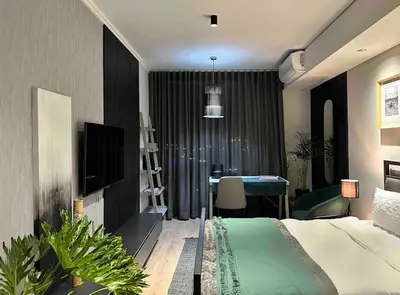 a bedroom with a bed and a desk in a room at Explore Ellipse - Emerald Studio in Midrand
