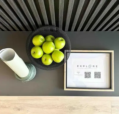 a bowl of green apples on a wall with a picture at Explore Ellipse - Emerald Studio in Midrand