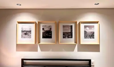 a wall with four framed pictures on a wall at Explore Ellipse - Emerald Studio in Midrand