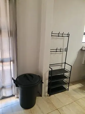 a black trash can in a room with a shelf at B&B Accommodation 109 Bezuidenhout in Mokopane