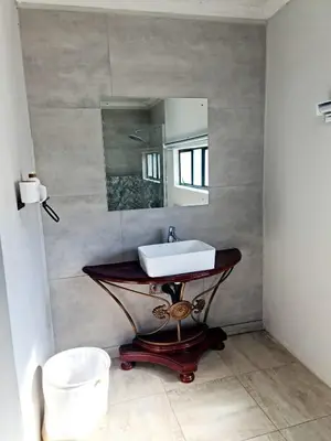 a bathroom with a sink and a mirror at B&B Accommodation 109 Bezuidenhout in Mokopane