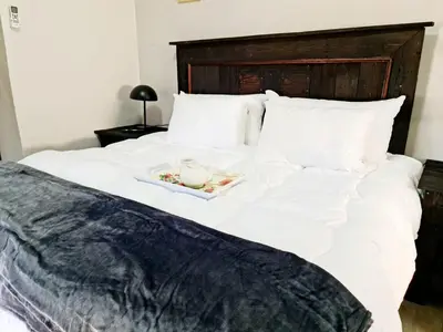 a white bed with a tray of food on it at B&B Accommodation 109 Bezuidenhout in Mokopane