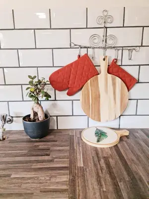 a kitchen with a wooden cutting board on a counter at B&B Accommodation 109 Bezuidenhout in Mokopane