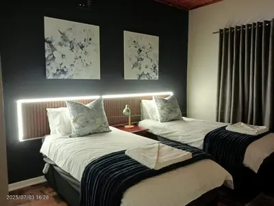 two beds in a room with two at Ode to Tranquility House - Pax 6 in Pretoria