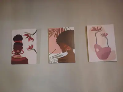 three paintings of a woman on a wall at Ode to Tranquility House - Pax 6 in Pretoria