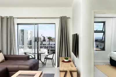 a living room with a couch and a view of a city at Golden Sunset Skyline View in Midrand