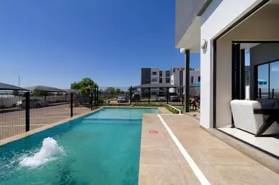 a swimming pool in the middle of a building at Golden Sunset Skyline View in Midrand