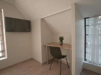 a room with a desk and a chair next to a window at Insolam Accommodation in Mokopane