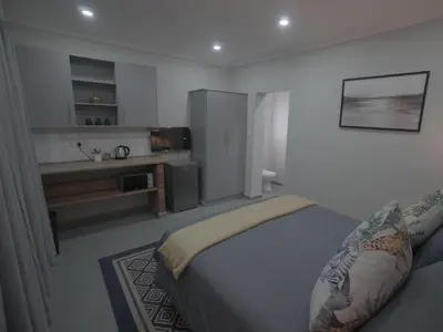 a bedroom with a bed and a sink at Insolam Accommodation in Mokopane