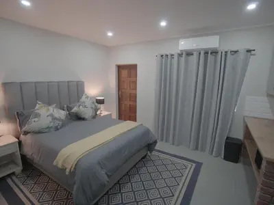 a bedroom with a bed and a window with curtains at Insolam Accommodation in Mokopane